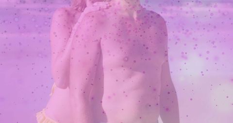 Couple embracing at beach with pink overlay for summer romance