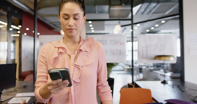 Caucasian Casual Businesswoman Using Smartphone in Sunny Office - Download Free Stock Images Pikwizard.com