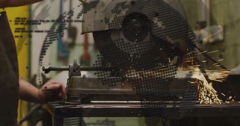 Industrial metalworker cutting steel with abrasive cutoff saw producing bright sparks