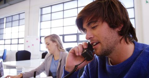 Young professionals communicating in office environment