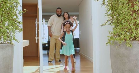 Excited Family Entering New Home with Child