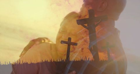Senior couple embracing at sunset with three crosses overlay, faith and devotion