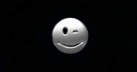 Metallic Winking Emoticon on Black Background