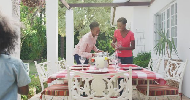 Mother and Daughter Setting Table for Outdoor Family Meal - Download Free Stock Images Pikwizard.com