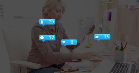 Multitasking woman reviewing documents at home office with social media reaction bubbles