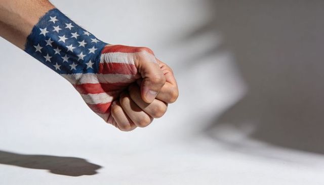 Clenching fist with american flag body paint conveying patriotism and protest