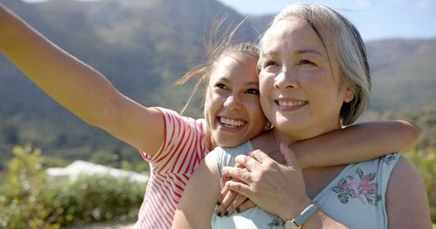Granddaughter Hugging Grandmother, Taking Selfie Outdoors Nature