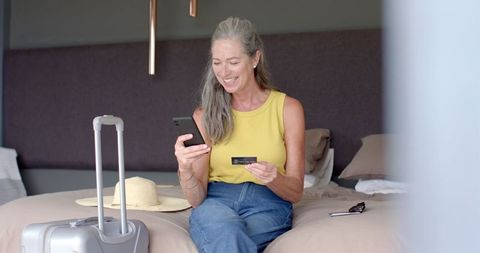 Mature Woman Shopping Online with Smartphone and Credit Card on Bed - Download Free Stock Images Pikwizard.com