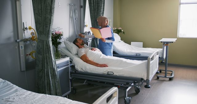 Nurse in a contemporary hospital room checking patient records at the bedside. Suitable for content related to healthcare, medical care, nursing, hospital facilities, patient recovery, clinical practice, and healthcare professionals' roles. Can be used in articles, websites, and publications focused on health and wellness.