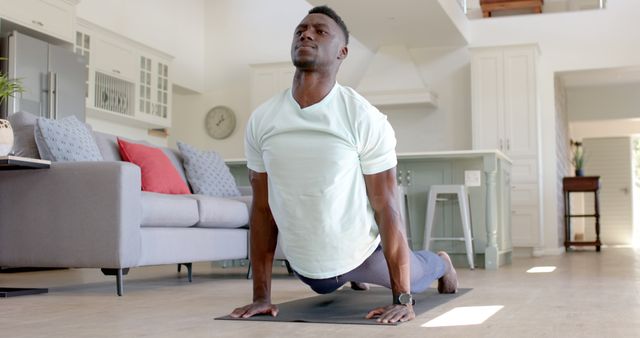 Man Practicing Yoga at Home with Upward Dog Pose - Download Free Stock Images Pikwizard.com