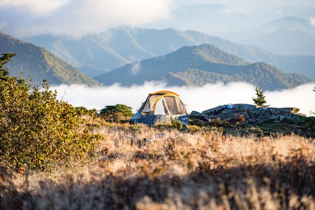 Tent on Mountain Top in Foggy Morning in Wilderness - Download Free Stock Photos Pikwizard.com
