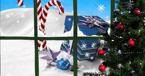 Festive candy canes and gifts viewed through frosted window