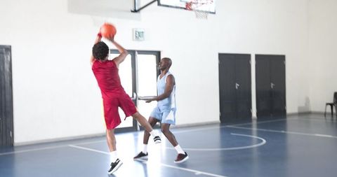 Basketball Players Competing Intense Match Indoor Court