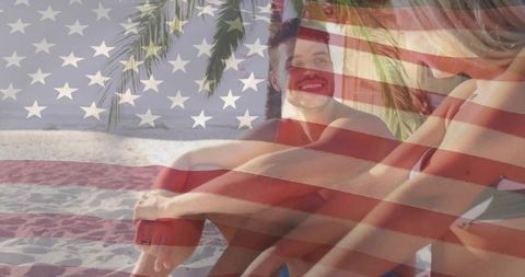 Young couple relaxing and smiling on tropical beach with american flag overlay