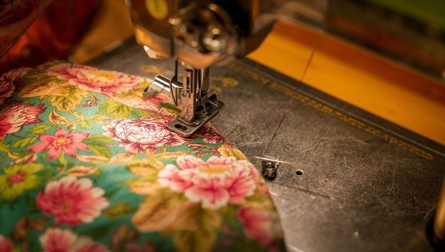 Vintage sewing machine stitching floral fabric
