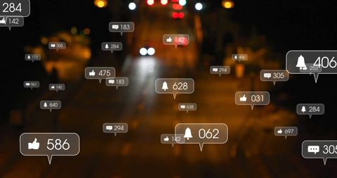 Social Media Notifications Floating Above City Street at Night