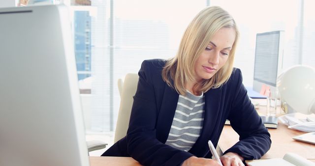 Businesswoman Working at Desk with Computer in Modern Office - Download Free Stock Images Pikwizard.com