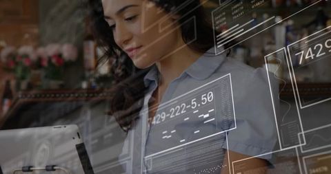 Modern Barista Interacting with Digital Interface in Café