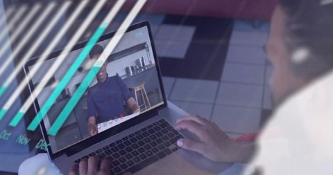 Typing in remote video meeting, man wearing wireless earbud in coworking kitchen with teal overlays