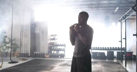 Determined Athlete Preparing in Modern Fitness Studio