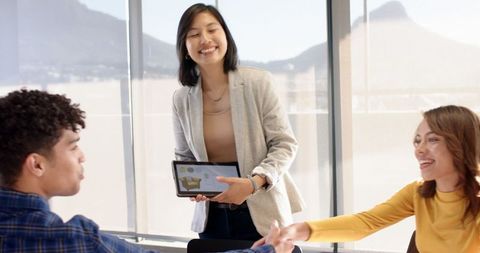 Diverse Coworkers Collaborating with Digital Technology in Modern Office