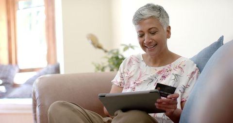 Senior Woman Shopping Online with Tablet and Credit Card