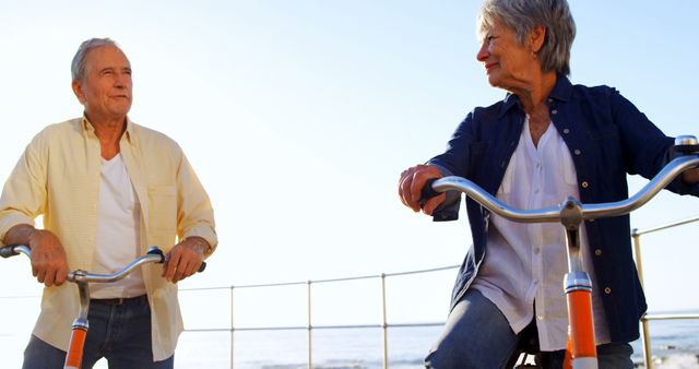 Senior Couple Riding Bicycles on Sunny Day Near the Ocean - Download Free Stock Images Pikwizard.com