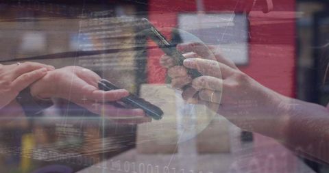 Businesswomen exchanging data with smartphones in tech environment