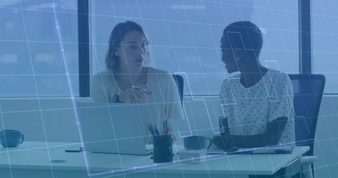 Two Businesswomen Discussing Data Insights in Modern Office