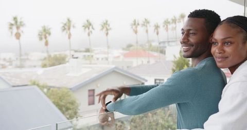 Romantic Couple Relaxing on Modern Balcony with Scenic View