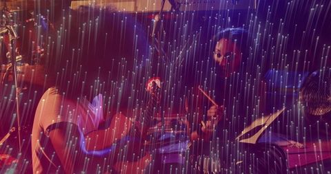 Home studio duo jamming under neon rain light, guitarist strumming, drummer keeping beat