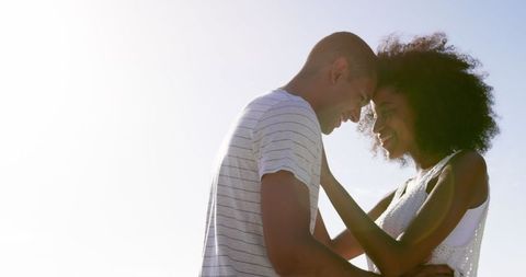 Young Couple Embracing on Sunny Beach