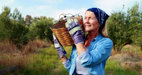 Caucasian Woman Joyfully Harvesting Outdoors in Garden