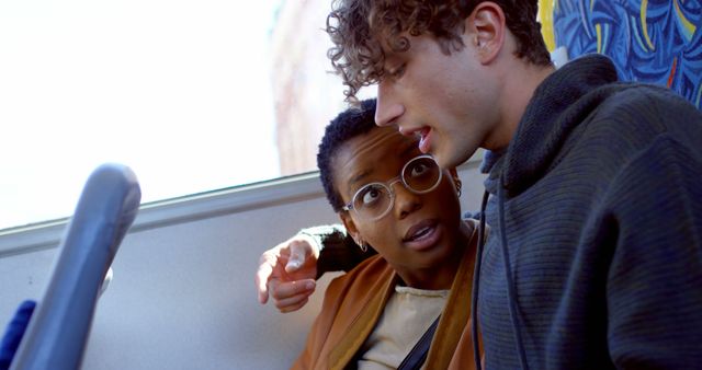 Two Young Adults Sharing Conversation on Bus - Download Free Stock Images Pikwizard.com