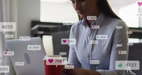 Young professional checking social media metrics on laptop and phone with floating engagement icons