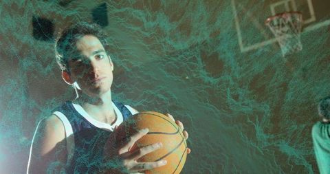 Focused athlete holding basketball under dynamic neon light effects