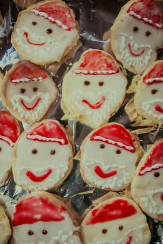 Festive Santa Claus Designed Holiday Cookies on Baking Sheet