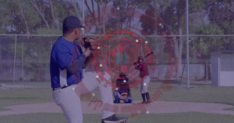 Hispanic pitcher preparing to throw on sunny baseball field