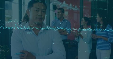 Colleagues Analyzing Data in Modern Meeting Room