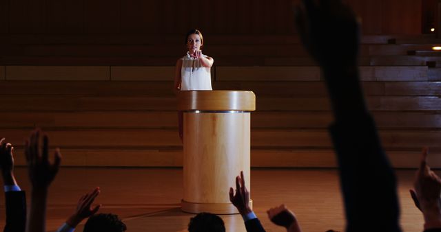 Woman Addressing Audience at Conference with Raised Hands - Download Free Stock Images Pikwizard.com