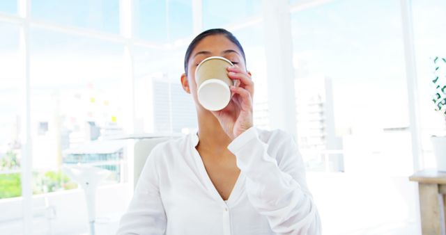 Young Professional Drinking Coffee in Modern Office - Download Free Stock Images Pikwizard.com