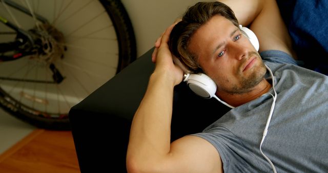 Relaxed Man Listening to Music on Headphones at Home - Download Free Stock Images Pikwizard.com