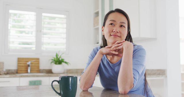 Pensive Woman Enjoying Coffee at Modern Kitchen Counter - Download Free Stock Images Pikwizard.com