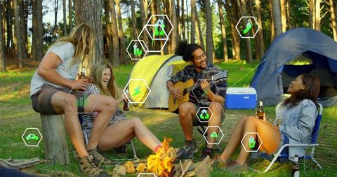 Friends Enjoying Campfire with Music and Beverages in Scenic Forest