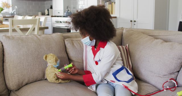 Young Girl Wearing Medical Outfit Treating Toy Bear on Sofa - Download Free Stock Images Pikwizard.com