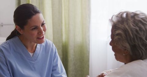 Nurse Supporting Elderly Woman during Pandemic in Retirement Home