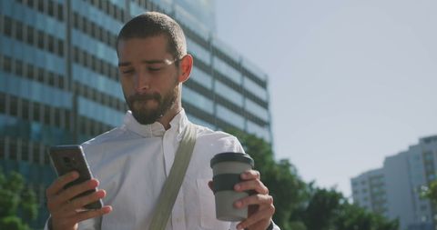 businessman using smartphone with coffee on city street - Download Free Stock Images Pikwizard.com