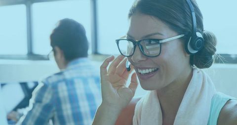Businesswoman Engaging with Clients via Headset in Modern Office
