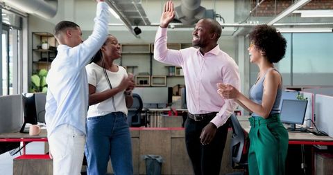 Diverse Business Team Achieving Success in Modern Office