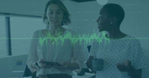 Coworkers collaborating over tablet and coffee with green data waveform overlay in office